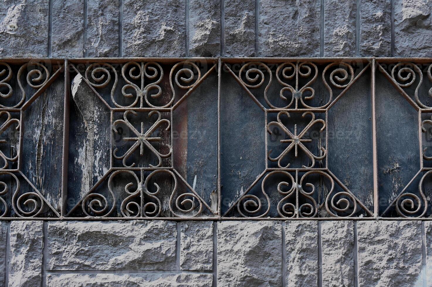 a decorative iron grille on a wall photo