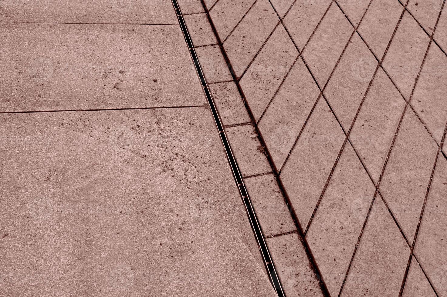a man is standing on a sidewalk with a skateboard photo