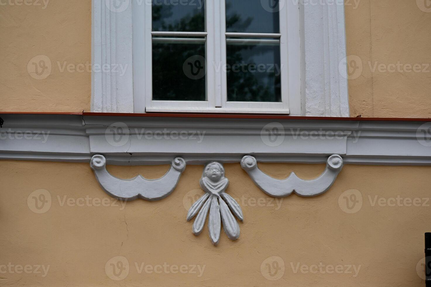 a window with decorative trim on the side of the building photo