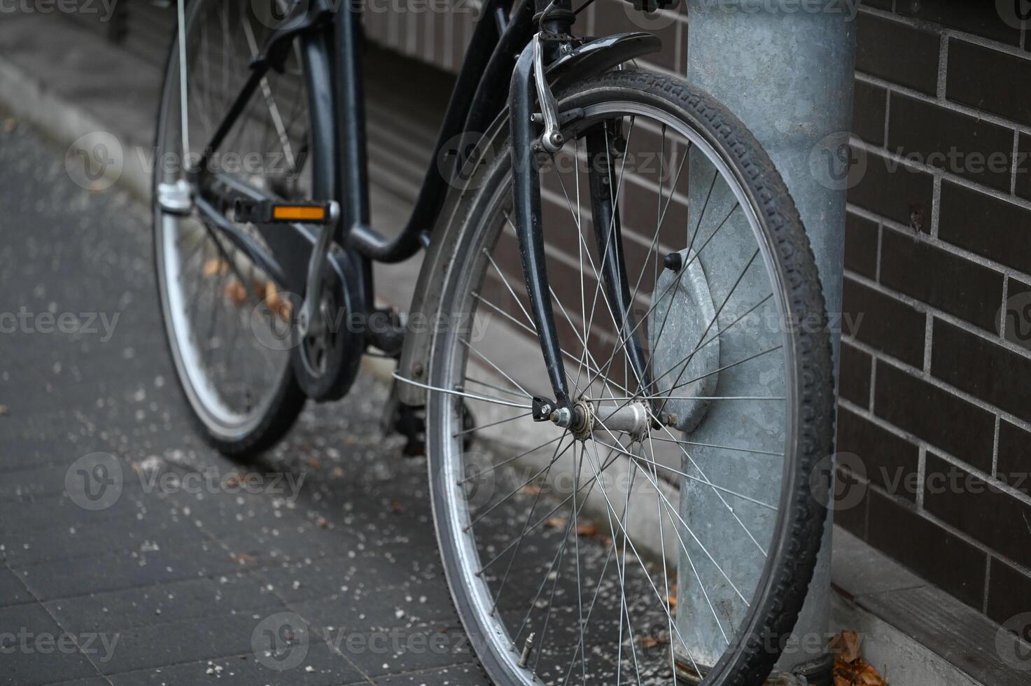 a bicycle is parked against a brick wall photo
