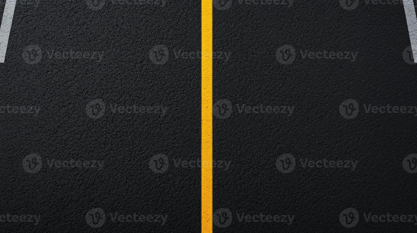 An empty asphalt road with two yellow lines photo