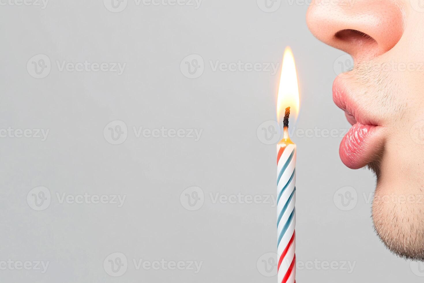 A man blowing out a candle with a birthday candle photo