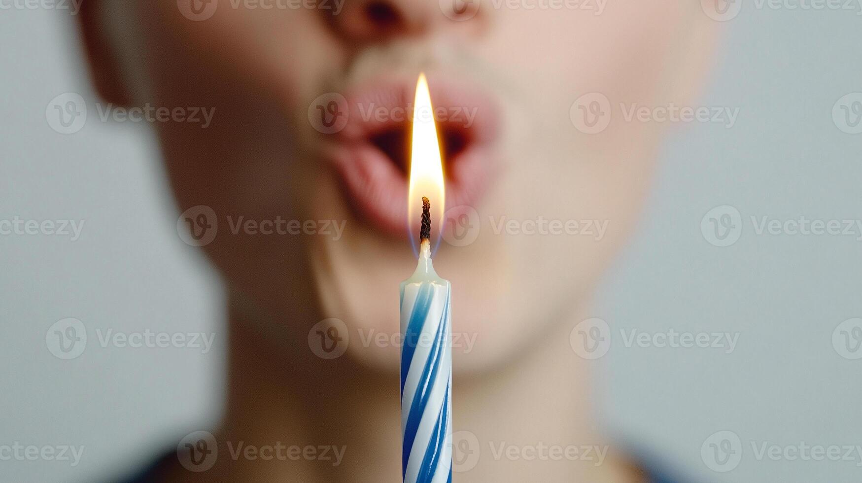 A woman blowing out a birthday candle photo