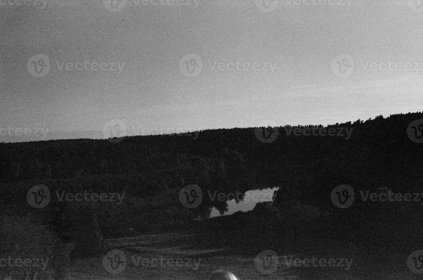 Black and white landscape photo with mountain in background