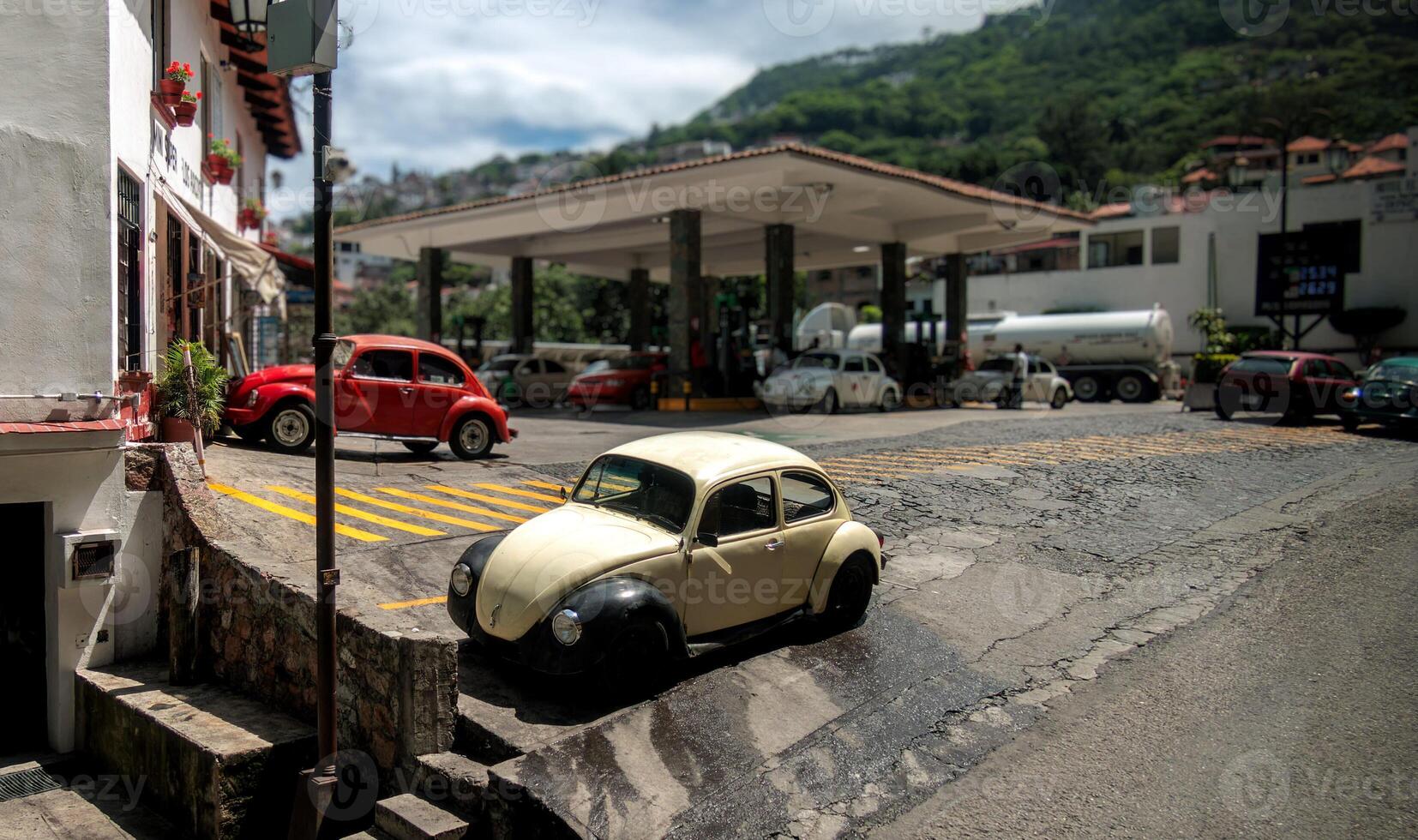 Classic Volkswagen Beetle parked on a steep incline in Taxco de Alarcon, Mexico photo