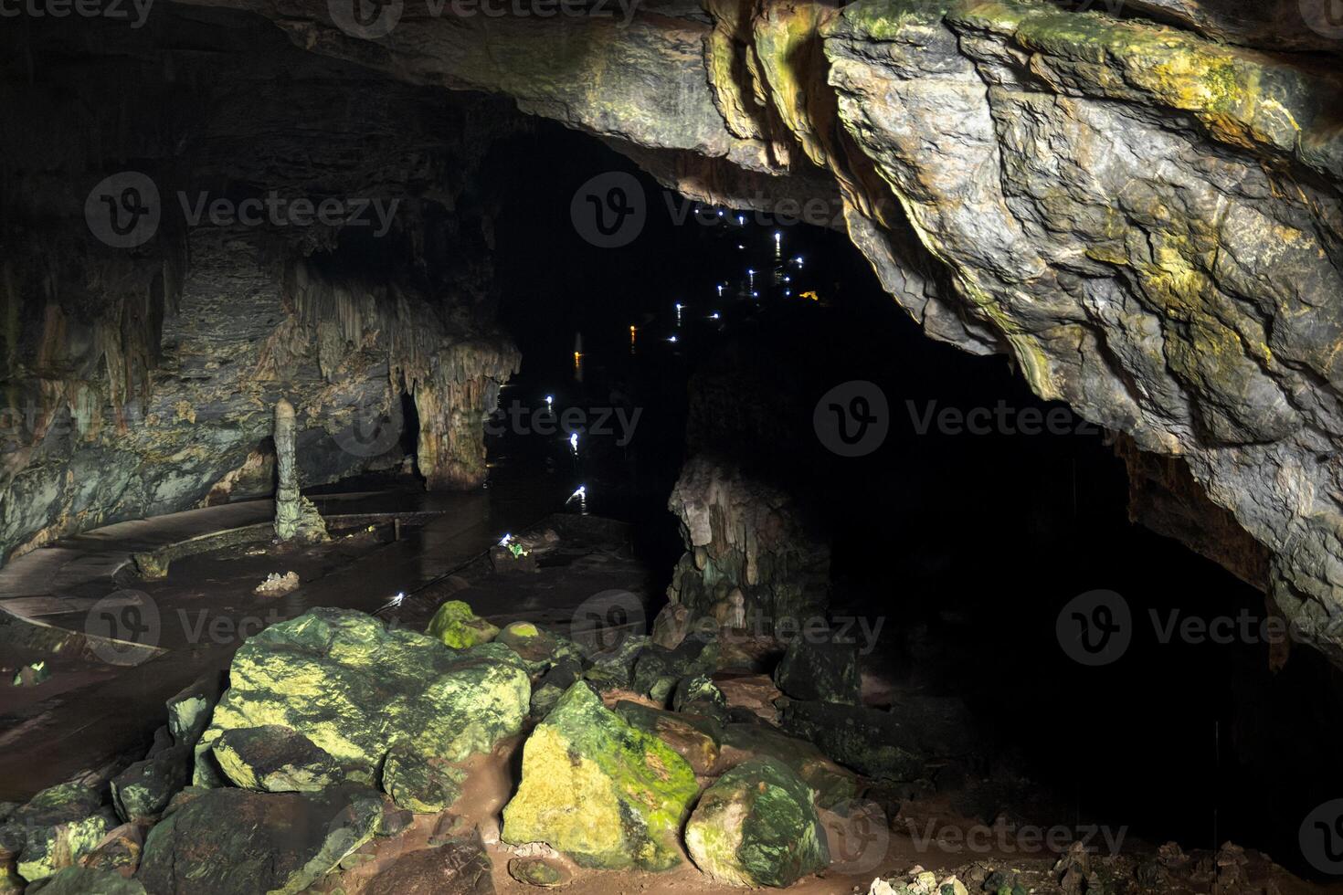 Visitors exploring the stunning Grutas de Cacahuamilpa National Park cavern at dusk photo