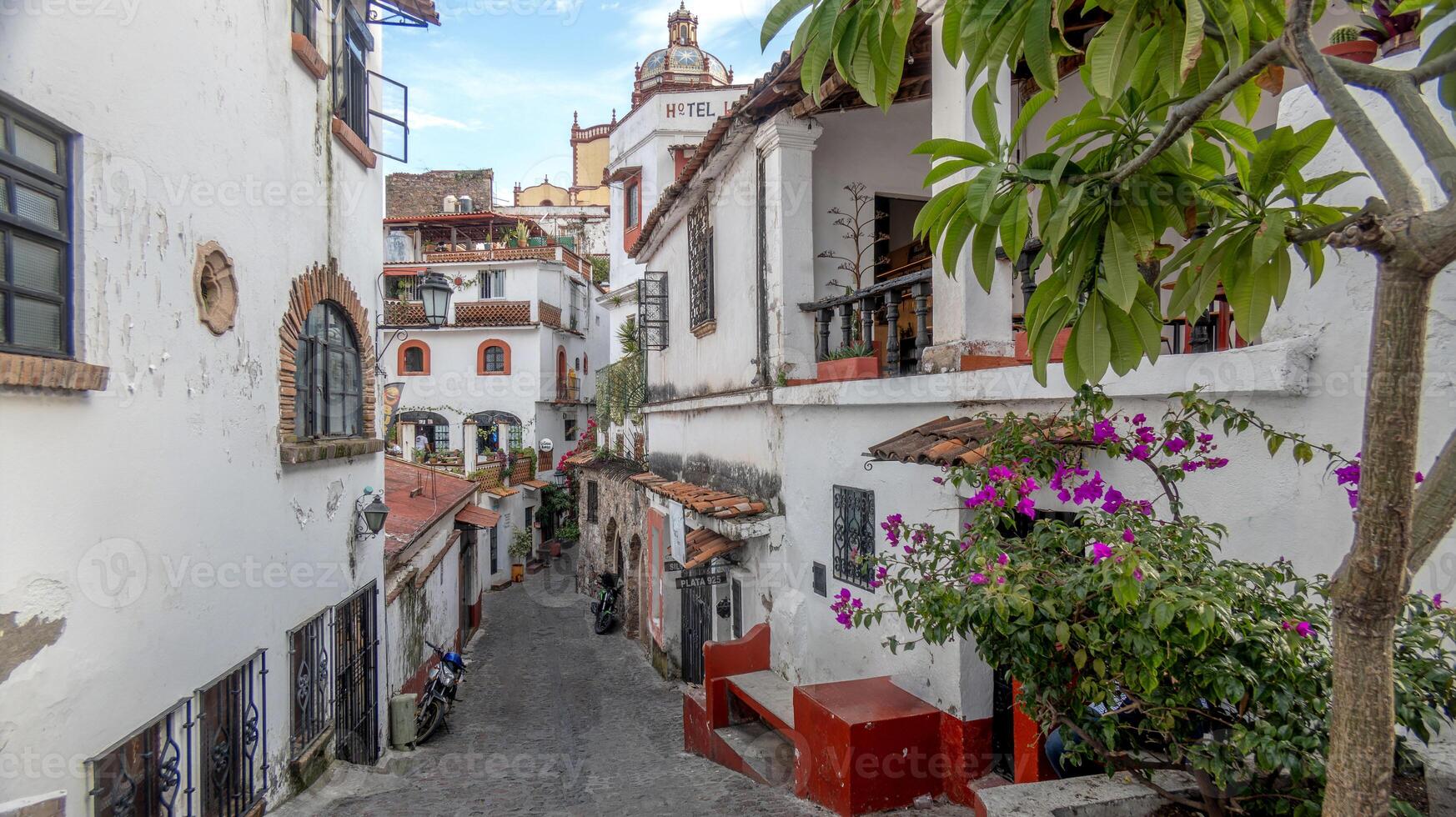 Charming streets of Taxco de Alarcon Mexico showcasing colonial architecture and vibrant flora photo