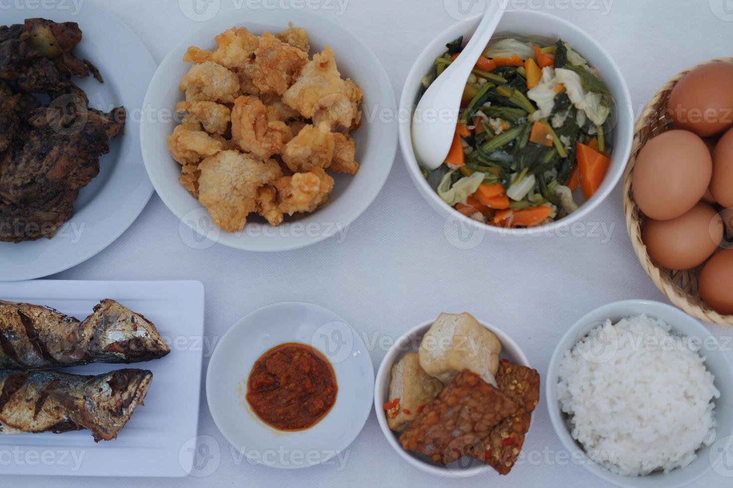 traditional Indonesian food arranged neatly on a white surface photo
