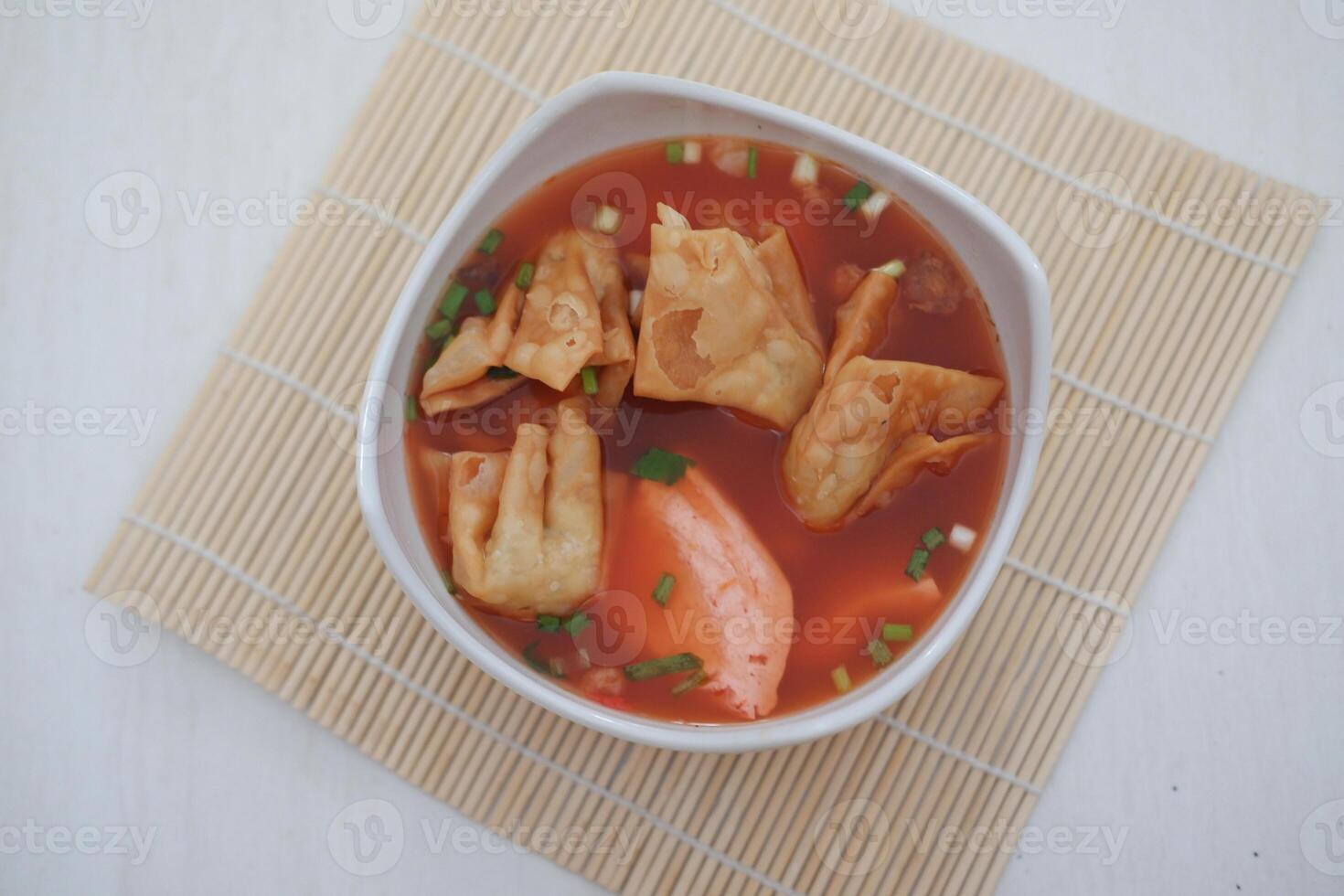 delicious red tofu soup with crackers photo