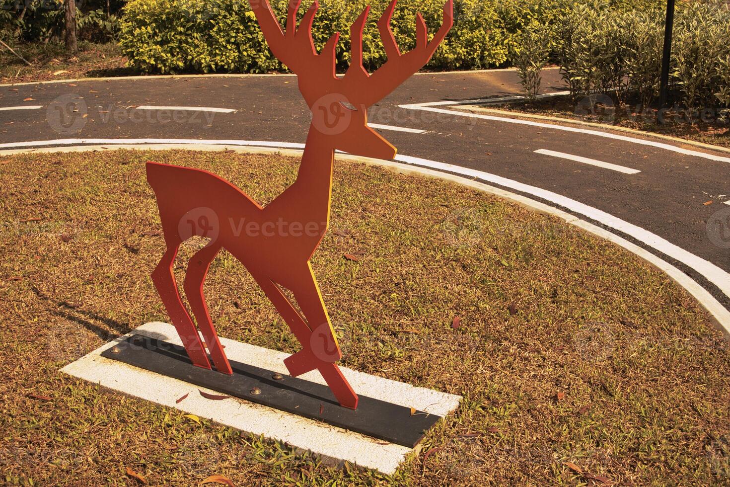 A park with vibrant metal giraffe sculptures painted in gradient colors stands out against the greenery in Taman Tasik Puteri Ijok. photo