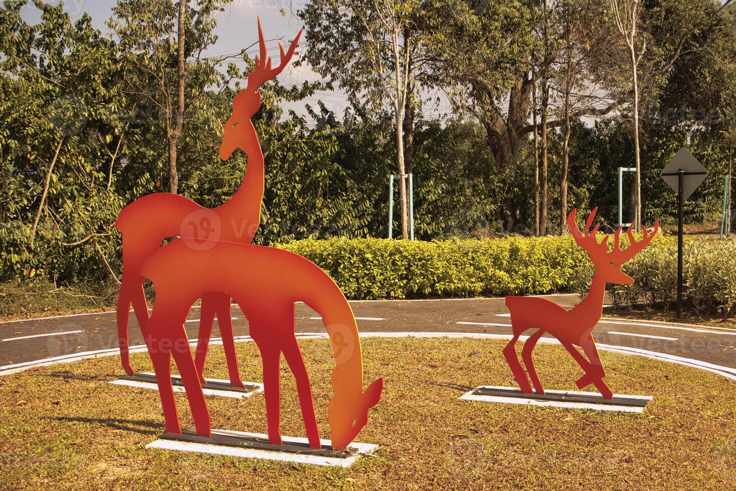 A park with vibrant metal giraffe sculptures painted in gradient colors stands out against the greenery in Taman Tasik Puteri Ijok. photo