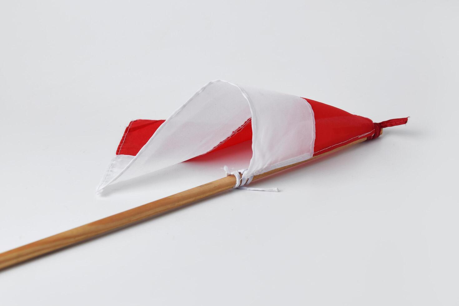 The red and white flag with a wooden pole is a symbol of the Indonesian nation photo