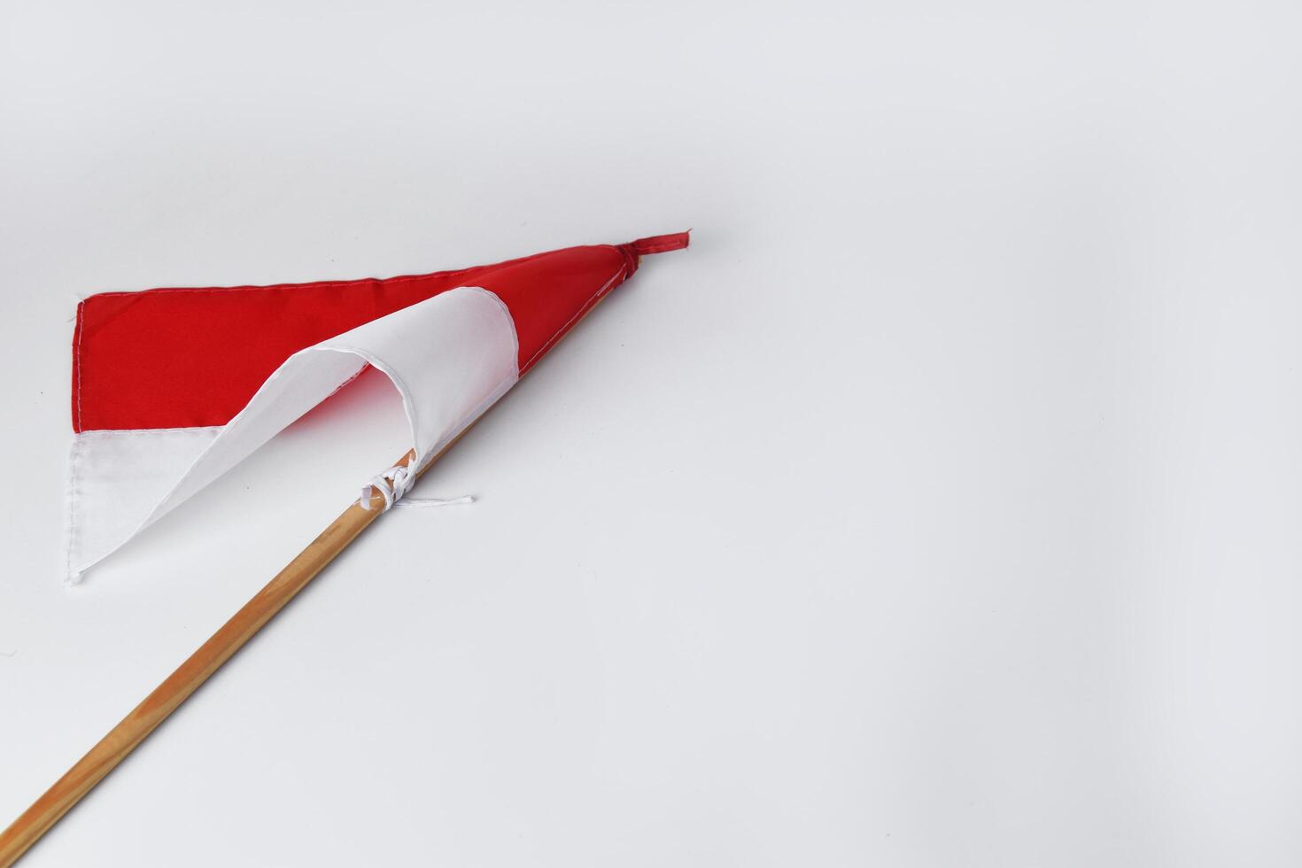 The red and white flag with a wooden pole is a symbol of the Indonesian nation photo