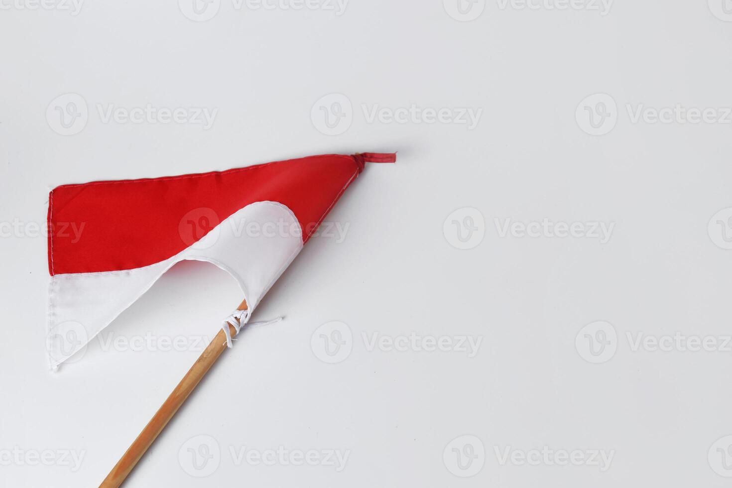 The red and white flag with a wooden pole is a symbol of the Indonesian nation photo