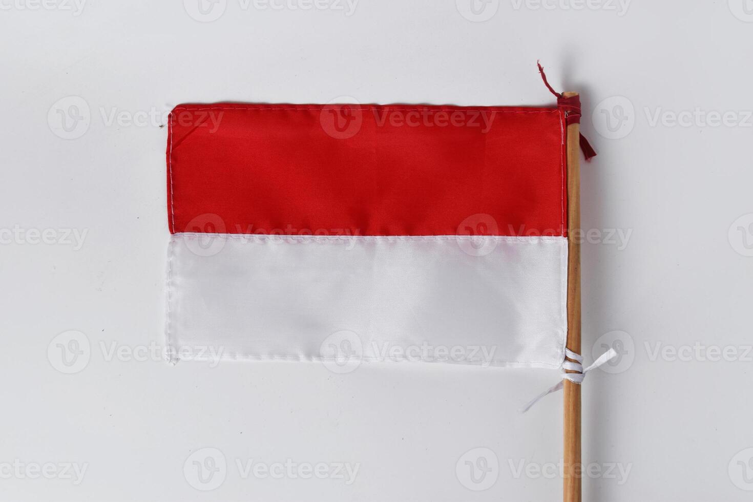 The red and white flag with a wooden pole photo