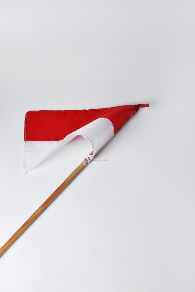 The red and white flag with a wooden pole is a symbol of the Indonesian nation photo