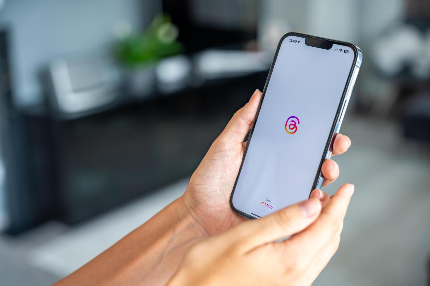 Prague, Czech republic - May 2, 2024. Woman holding iPhone with logo of application Instagram on the screen, using mobile application for business home. High quality photo