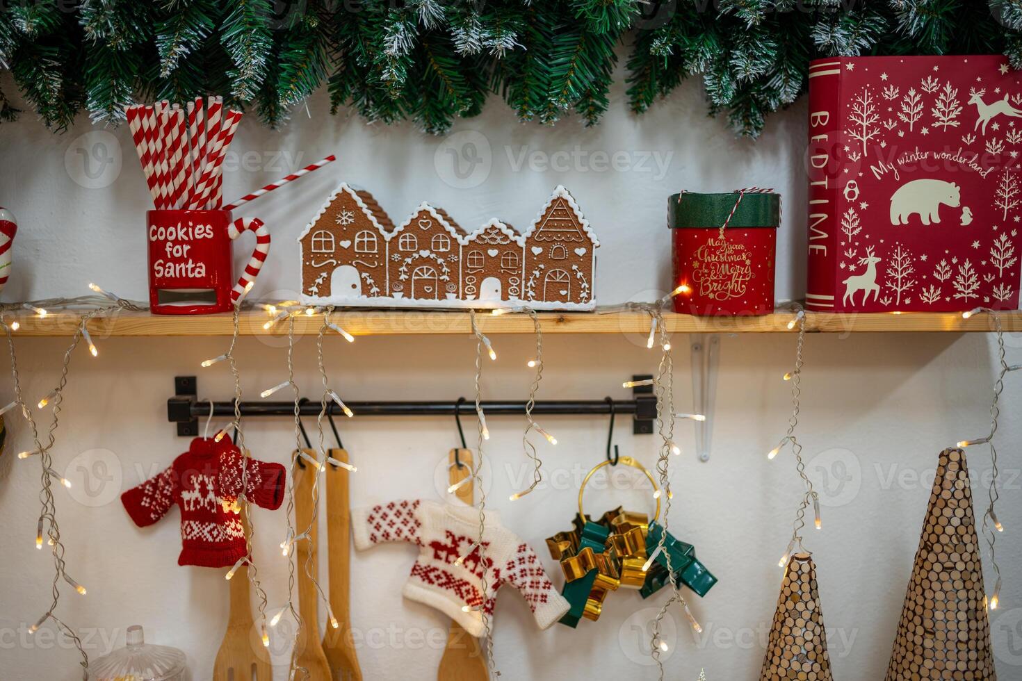 Christmas composition on the shelf in the kitchen interior. Beautiful decoration. Christmas trees, light and accessories. Merry Christmas and Happy Holidays. High quality photo