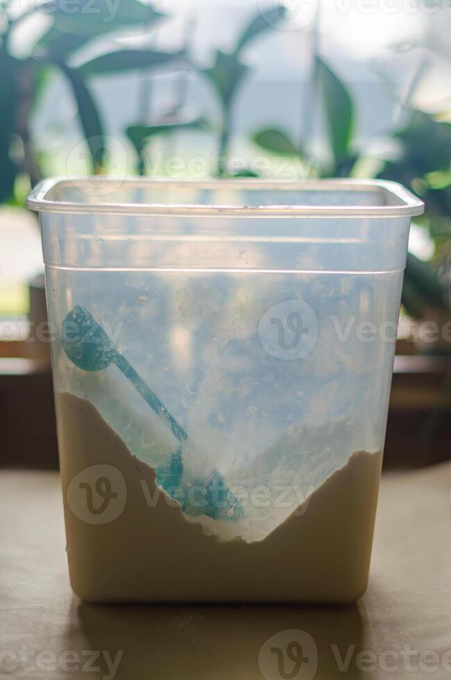 Green scoop resting in a container of flour, ready for baking preparations. High quality photo