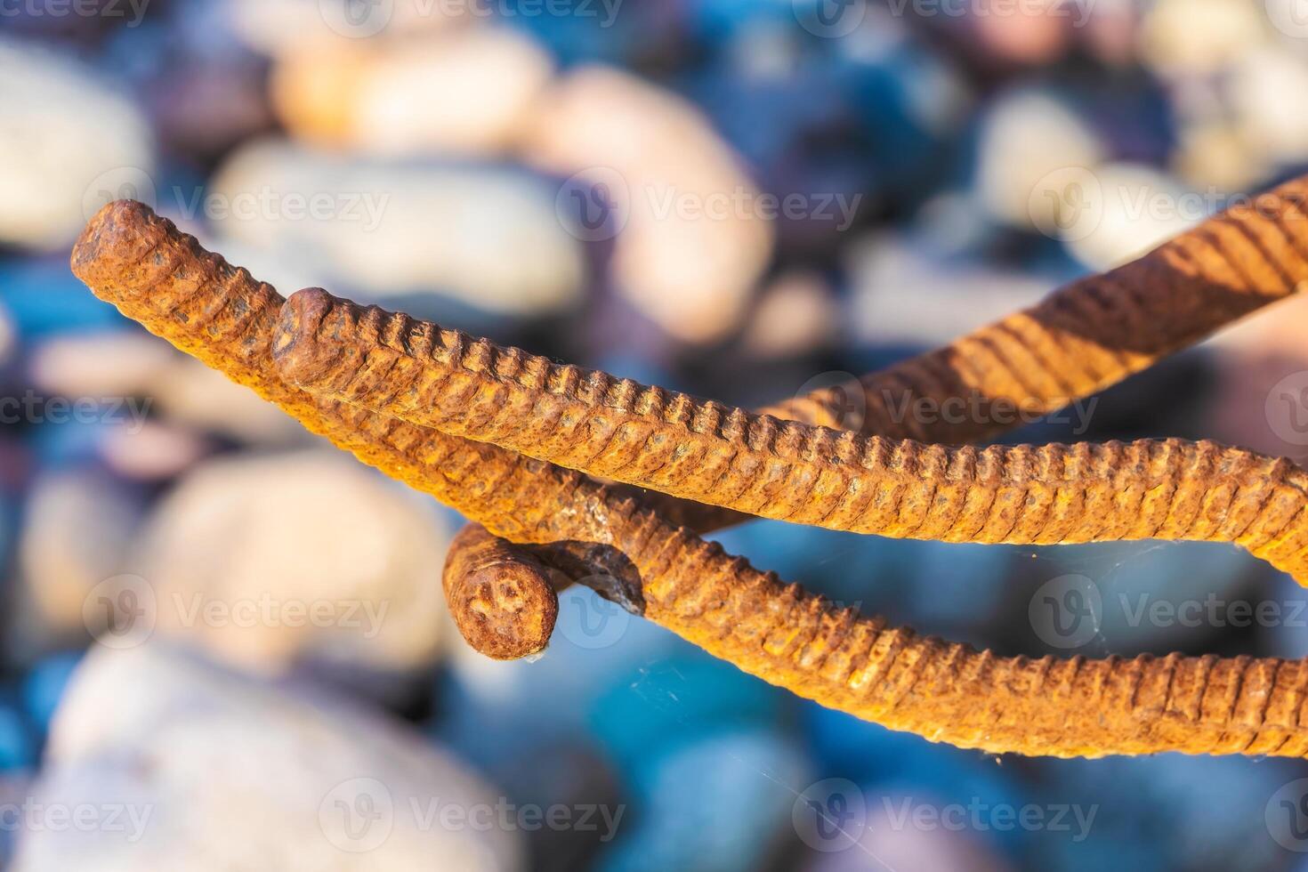 Beautiful natural installation of metal rods on the background of stones photo