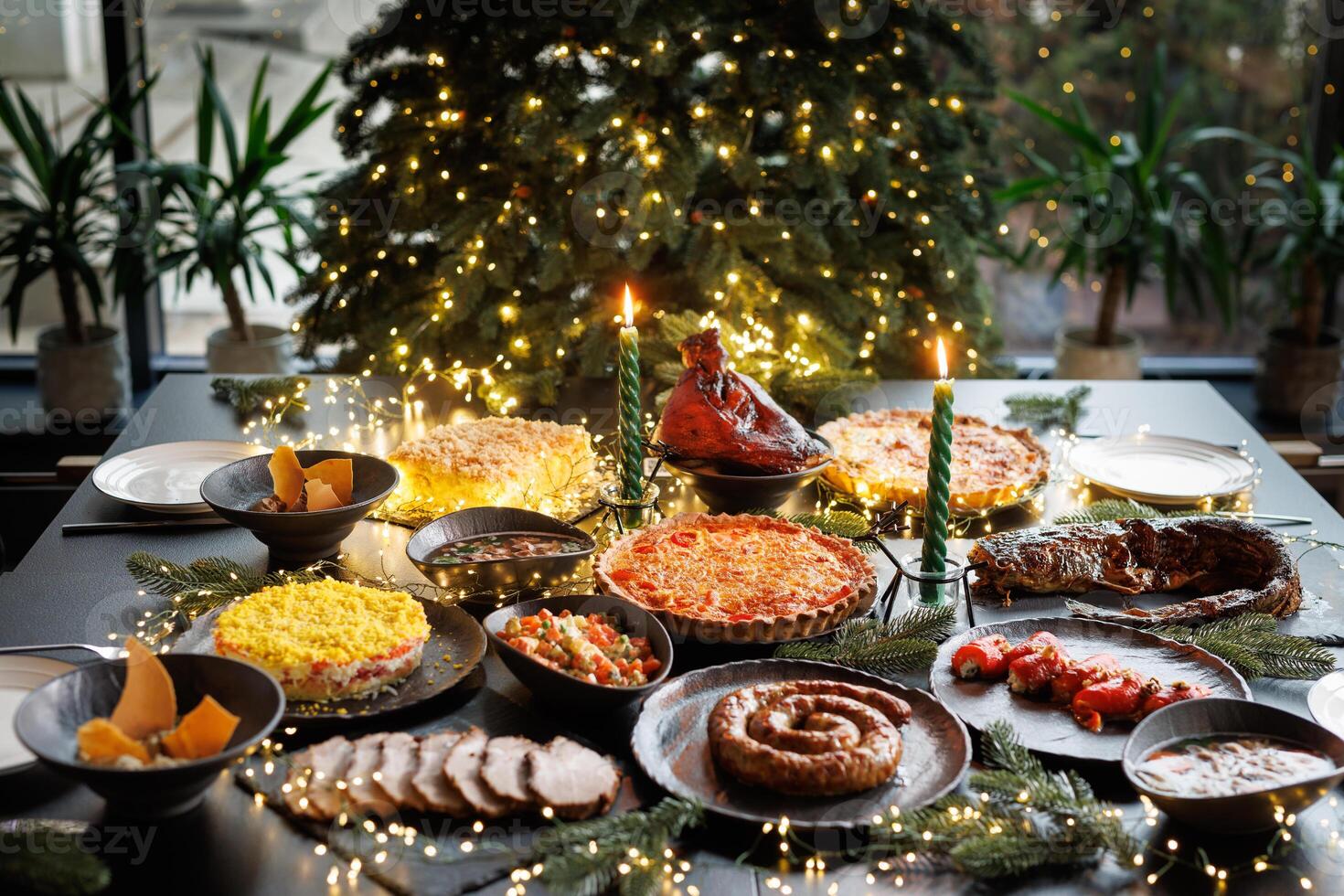 Festive table setting with Christmas decorations and burning candles in the dining room, cozy romantic Christmas in the evening atmosphere photo
