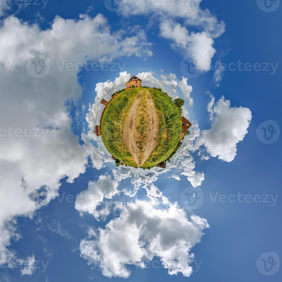 tiny planet in blue sky with clouds of old abandoned ruined church. Transformation of spherical 360 panorama in abstract aerial view. photo