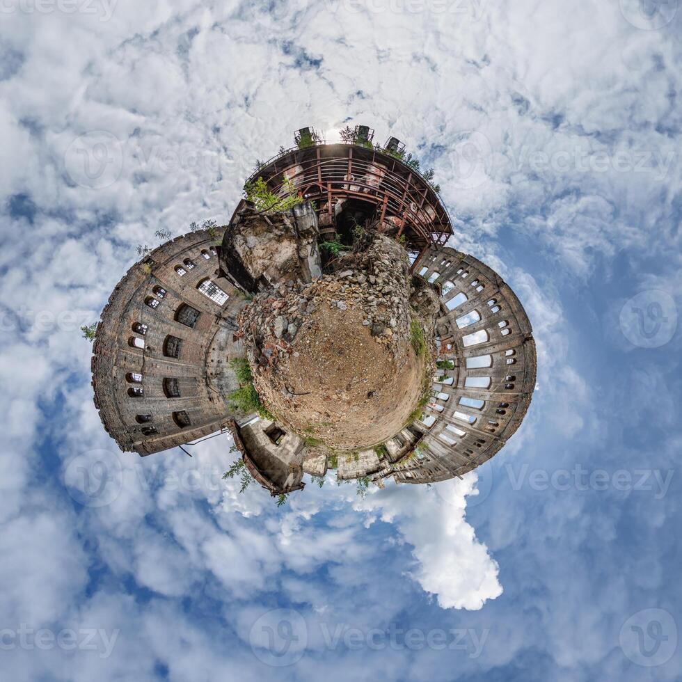 tiny planet in blue sky with clouds of old abandoned ruined church. Transformation of spherical 360 panorama in abstract aerial view. photo