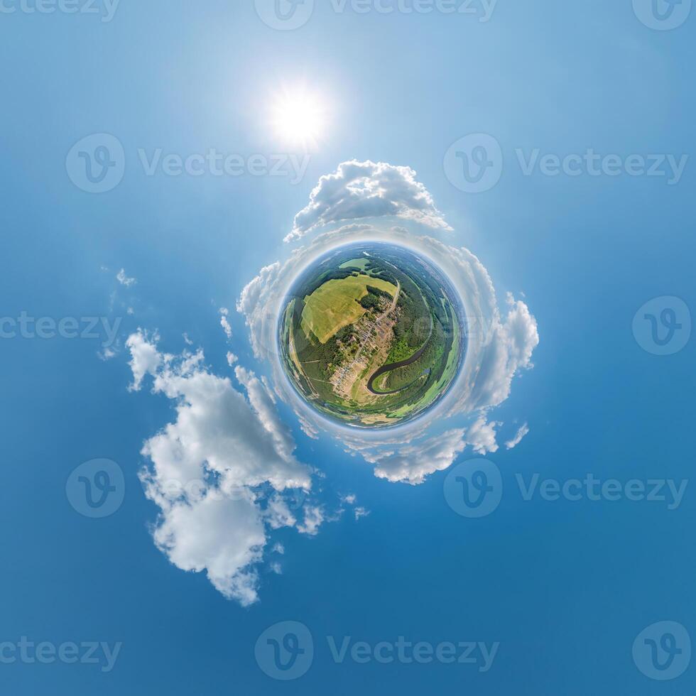 simple little tiny planet without buildings in blue sky with sun and beautiful clouds. Transformation of spherical panorama 360 degrees. Spherical abstract aerial view. Curvature of space. photo