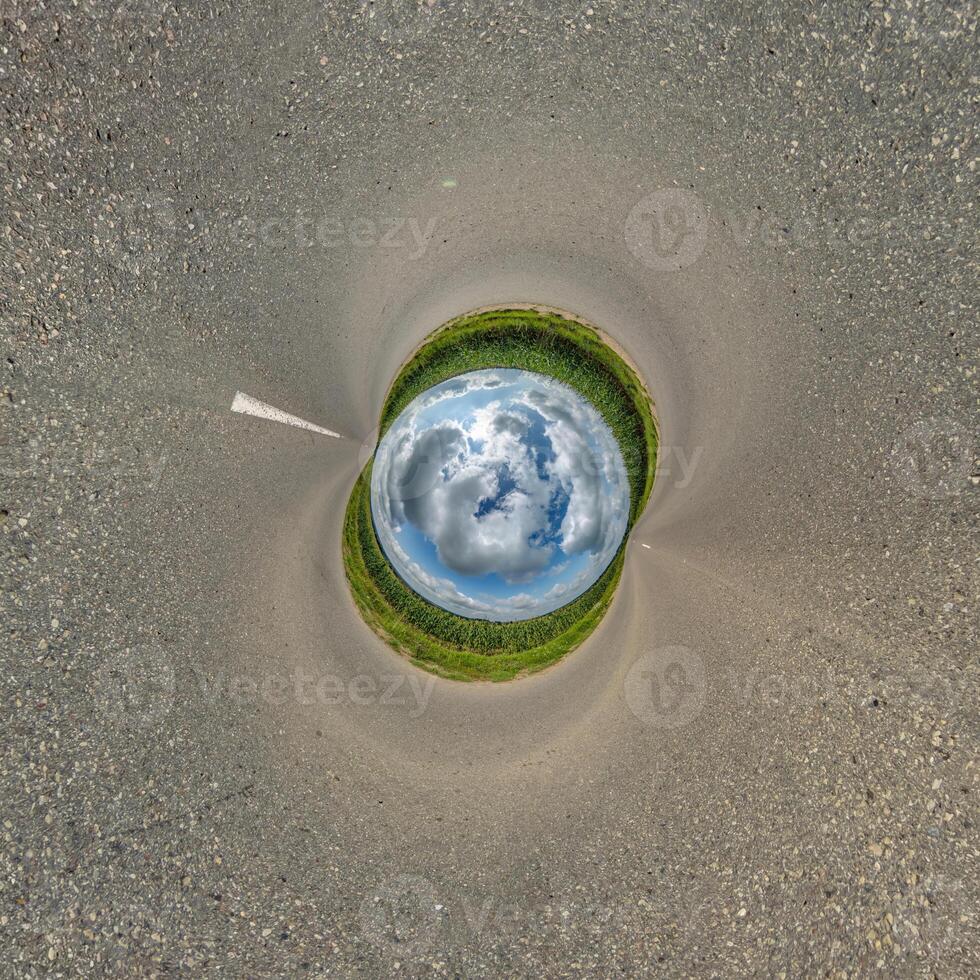 blue hole sphere or globe little planet inside green dry grass or stone with sand frame background photo