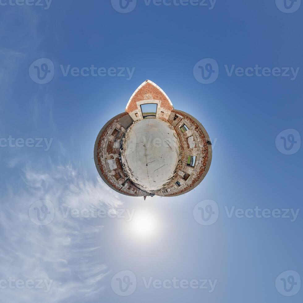 tiny planet in blue sky with clouds of old abandoned ruined church. Transformation of spherical 360 panorama in abstract aerial view. photo