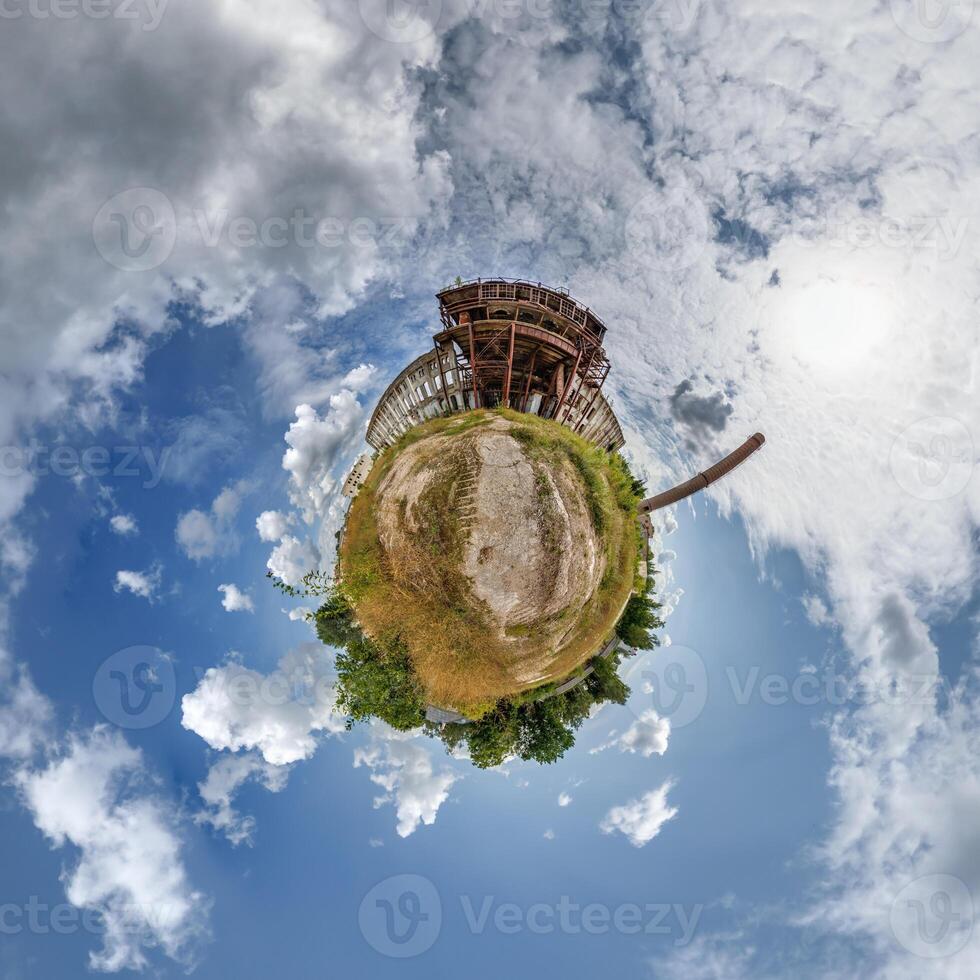 tiny planet in blue sky with clouds of old abandoned ruined church. Transformation of spherical 360 panorama in abstract aerial view. photo