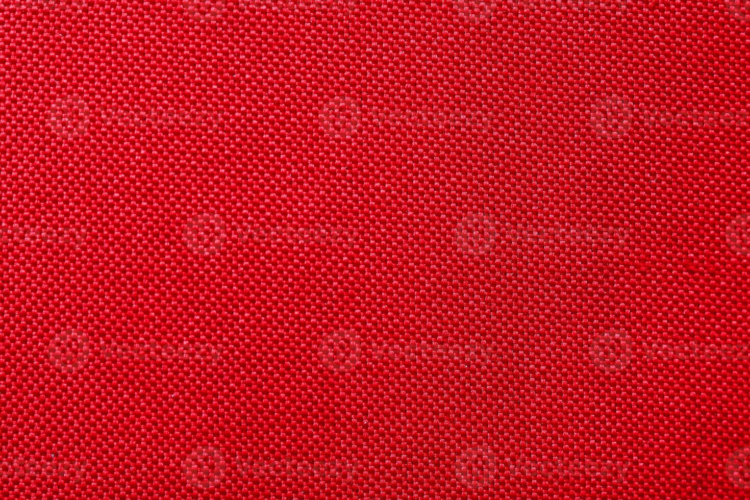 Red fabric texture useful as a background with copy space in high-resolution photo