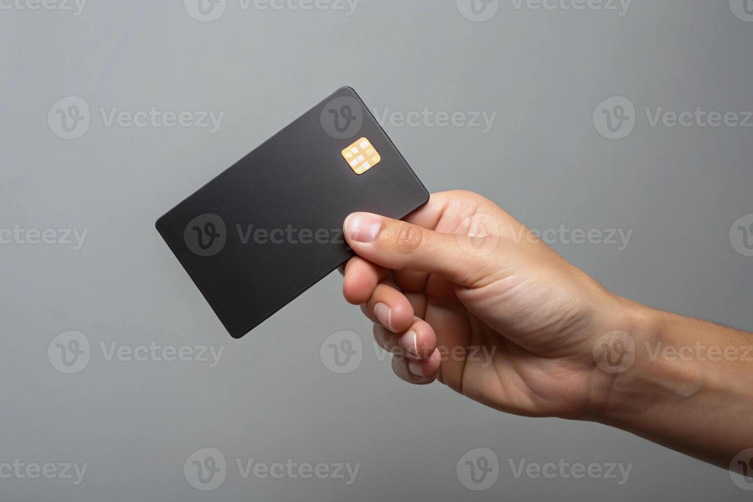 Blank black credit card isolated on grey background, photo studio hand hold blank credit card