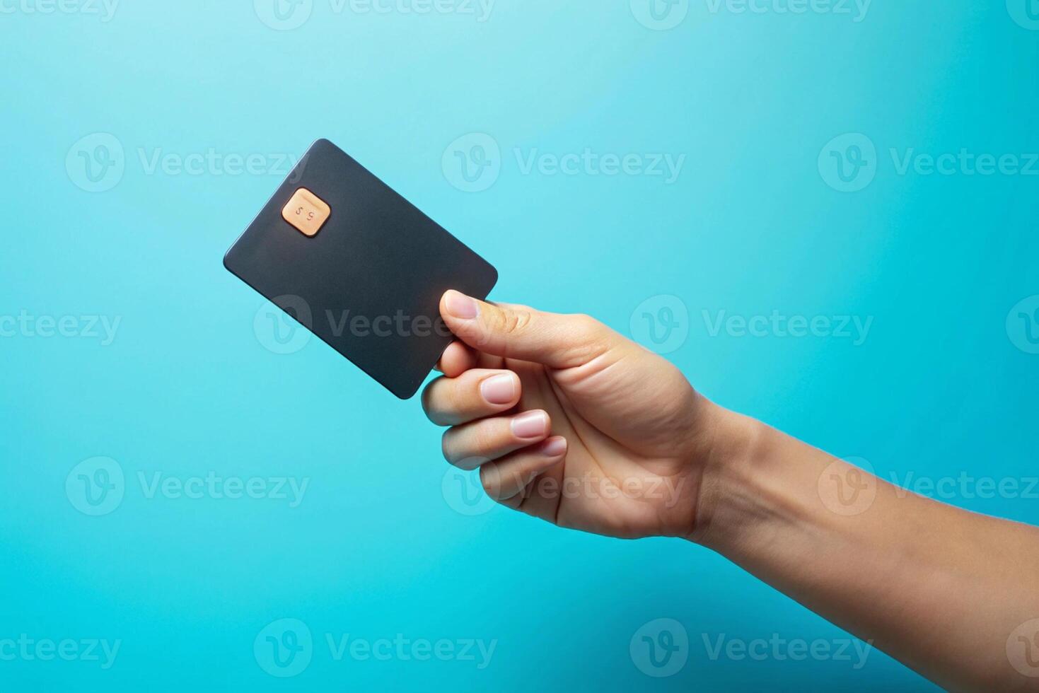 Blank black credit card isolated on blue background, photo studio hand hold blank credit card