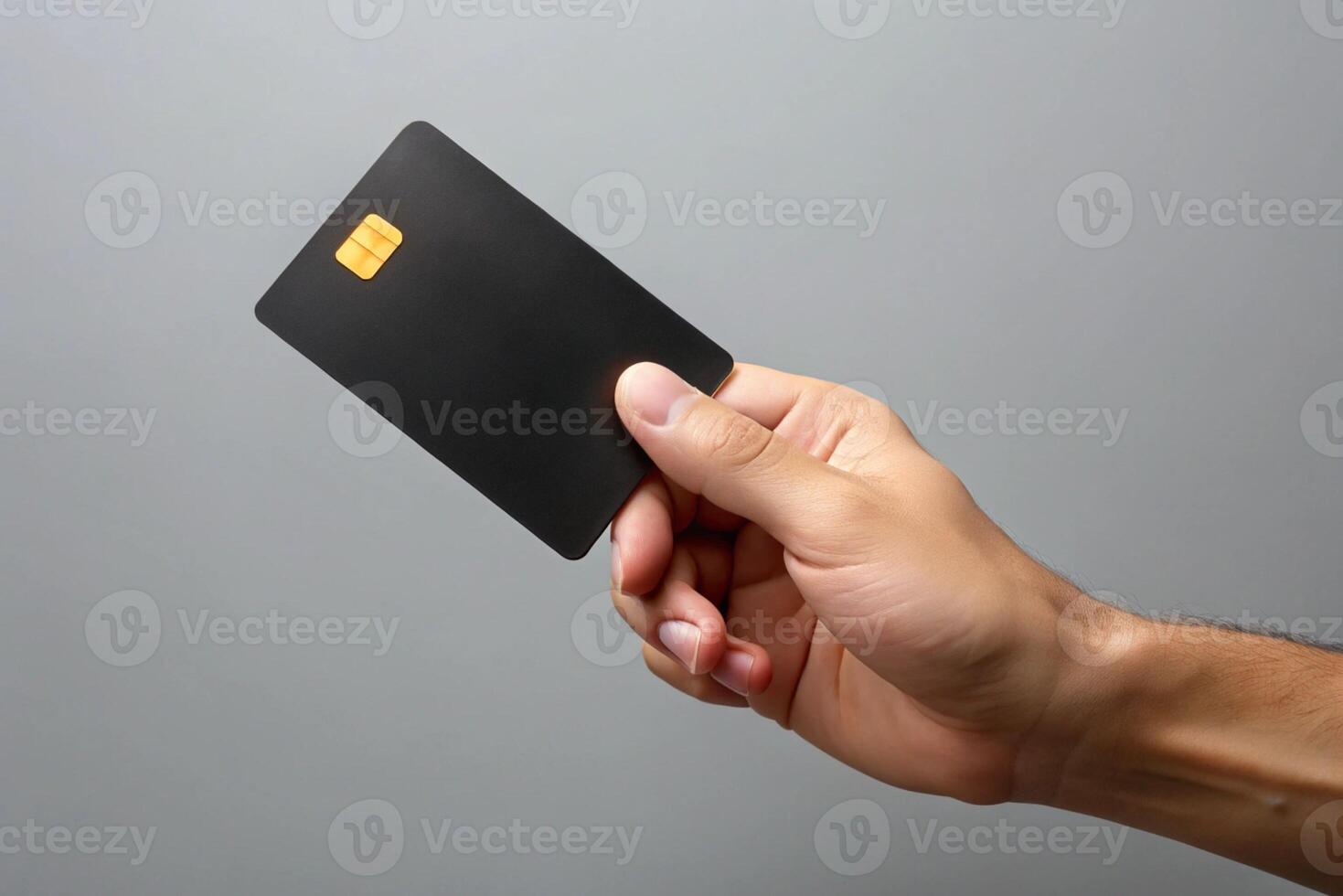 Blank black credit card isolated on grey background, photo studio hand hold blank credit card