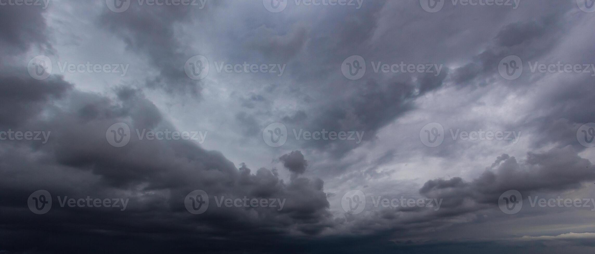 Bad or moody weather sky and environment. carbon dioxide emissions, greenhouse effect, global warming, climate change. The dark sky with heavy clouds converging and a violent storm before the rain. photo
