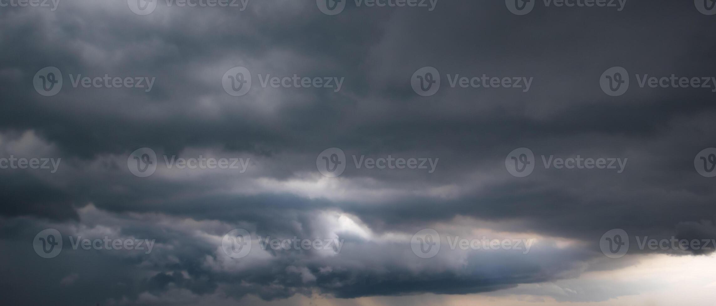 Bad or moody weather sky and environment. the dark sky with heavy clouds converging and a violent storm before the rain. carbon dioxide emissions, greenhouse effect, global warming, climate change. photo