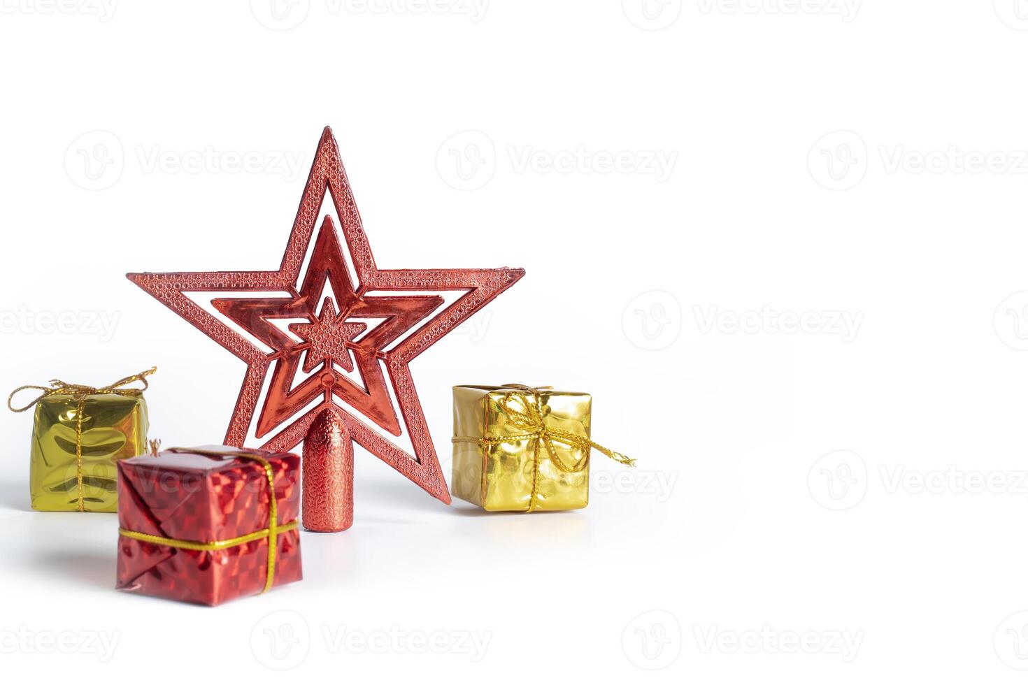 Festive red Christmas star ornament with colorful gift boxes on white background photo