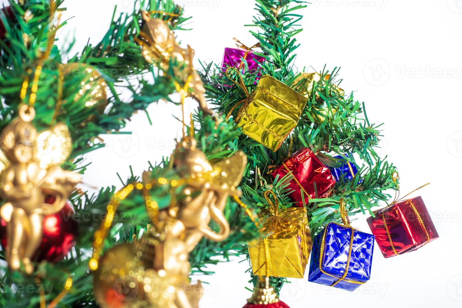 Festive Christmas Tree with Ornaments and Gifts on White Background for Holiday Celebrations photo