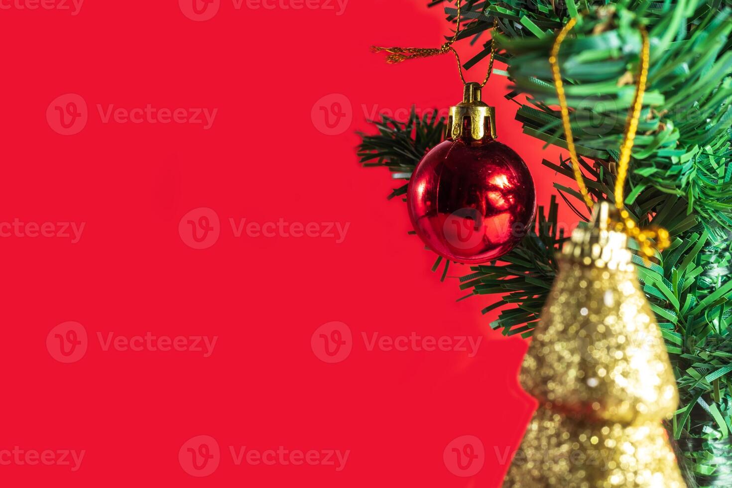Christmas tree with ornaments on red background photo