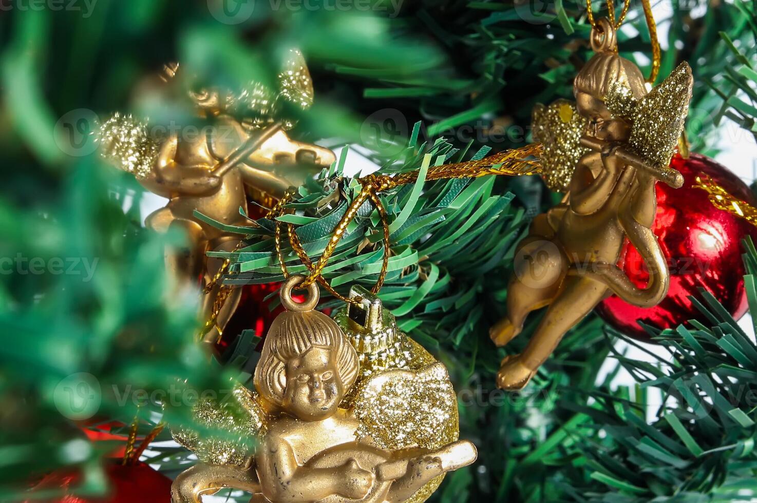 Christmas tree ornament with gold angel and red ball photo