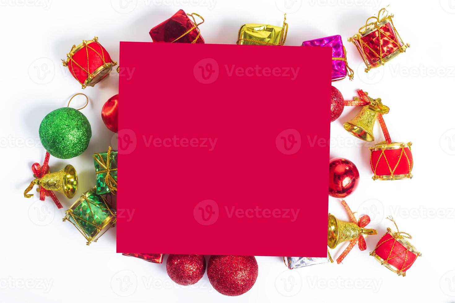 Christmas decorations and red paper on white background photo