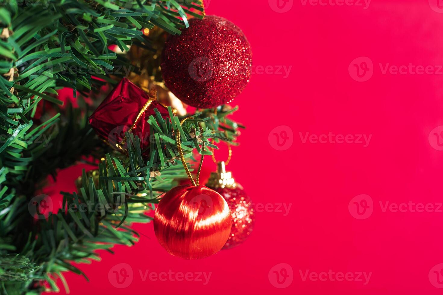 Christmas tree with ornaments on red background photo