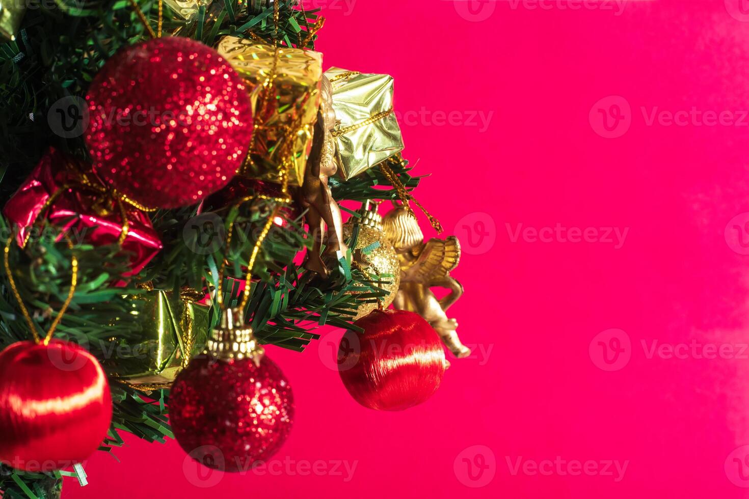 Christmas tree with ornaments on pink background photo