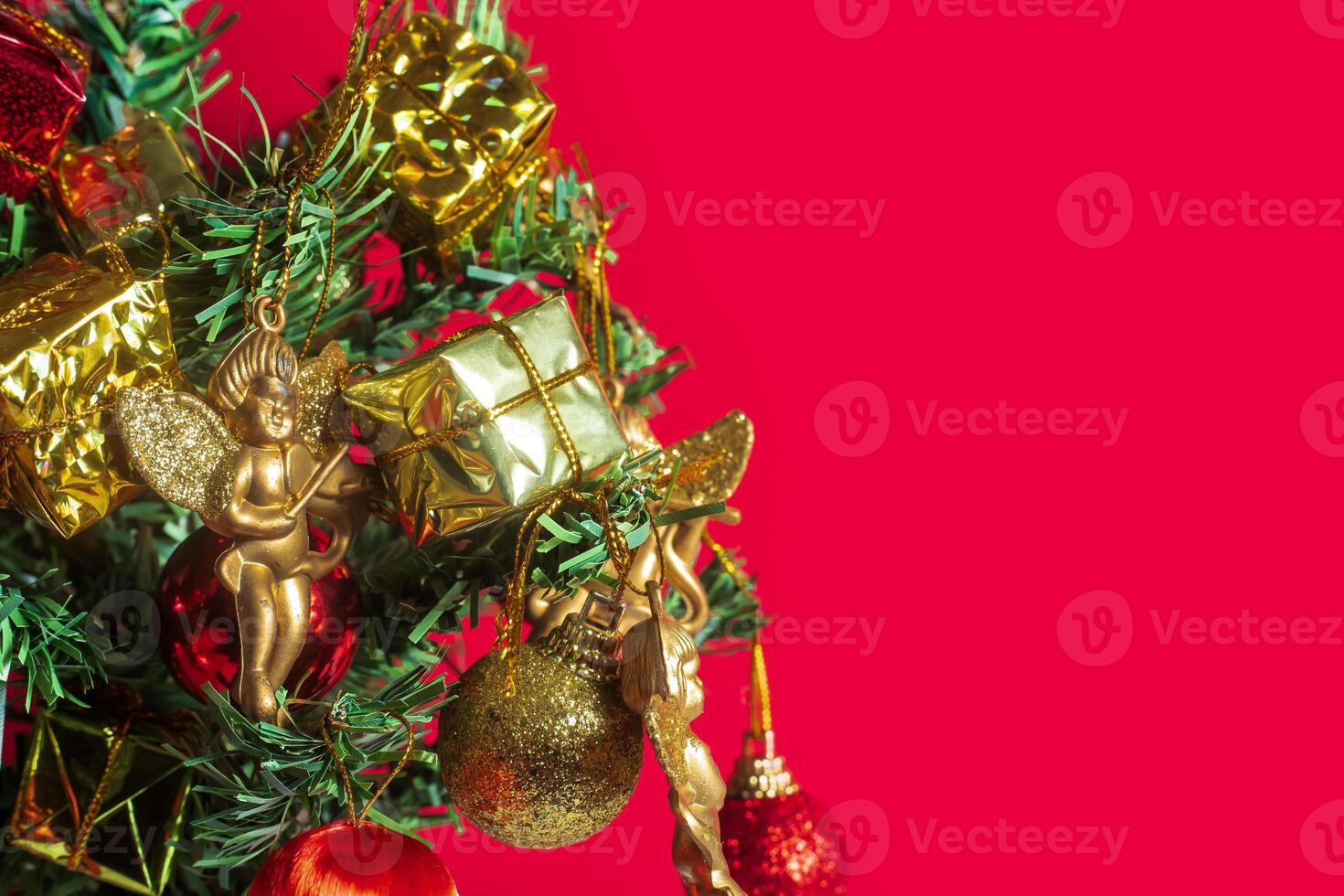 Christmas tree with ornaments on red background photo
