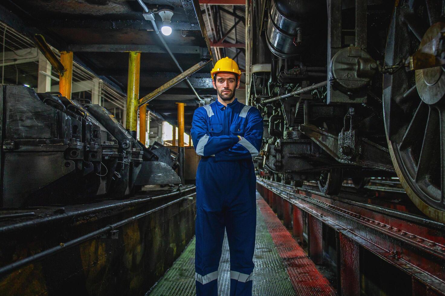 man in a blue and yellow outfit stands in a dark room photo