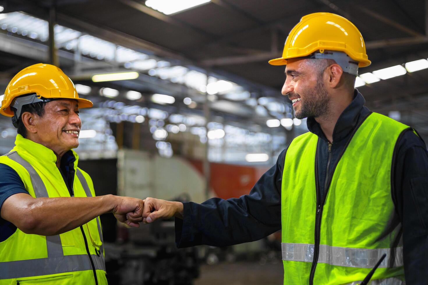 Two men in yellow safety gear shake hands photo