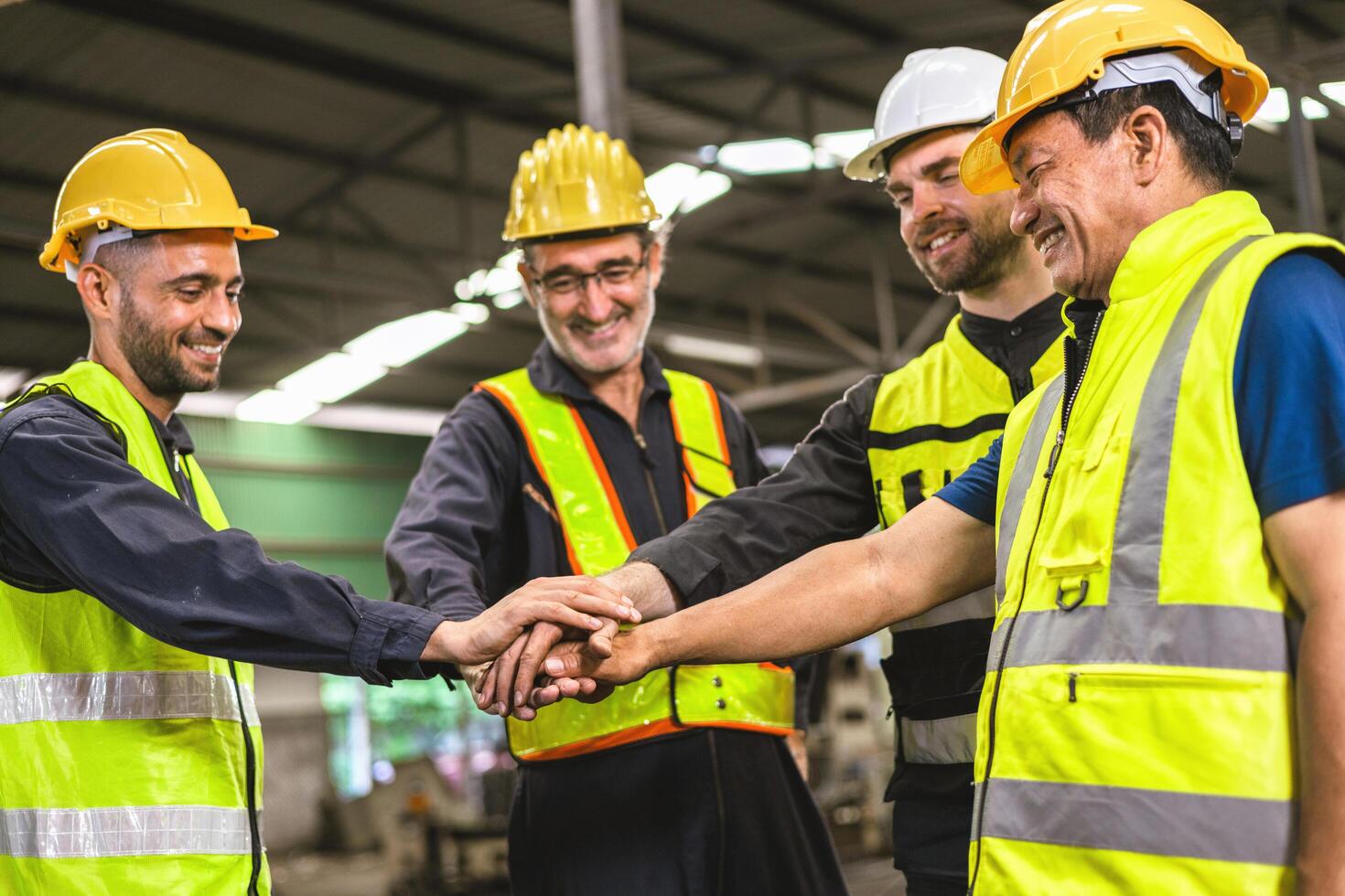 group of construction workers are high fiving each other photo