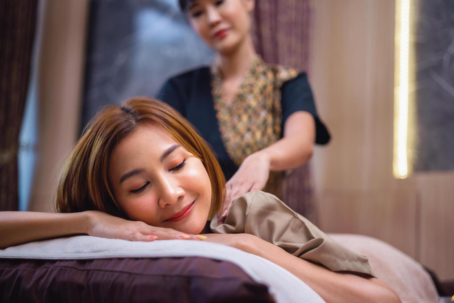woman is getting a massage from a masseuse photo