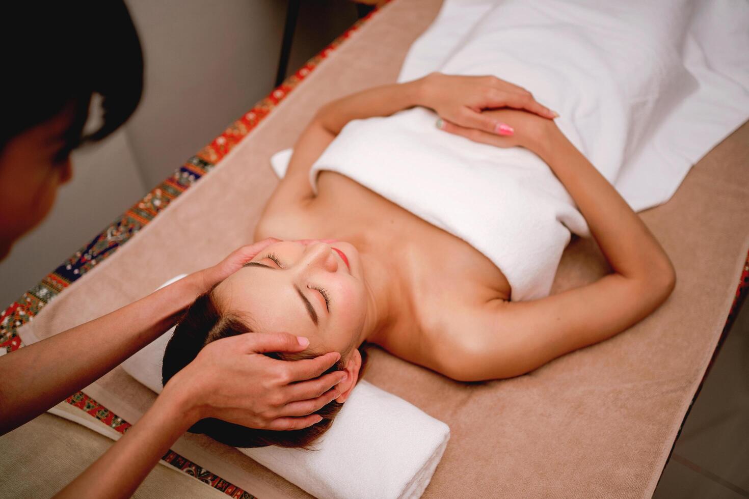 woman is getting a massage on a table photo